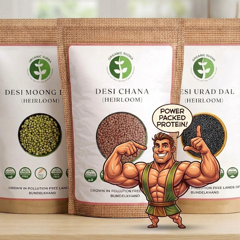Three packages of 'Desi Moong Heirloom', 'Desi Chana Heirloom', and 'Desi Urad Dal Heirloom' with a cartoon character on a wooden surface.